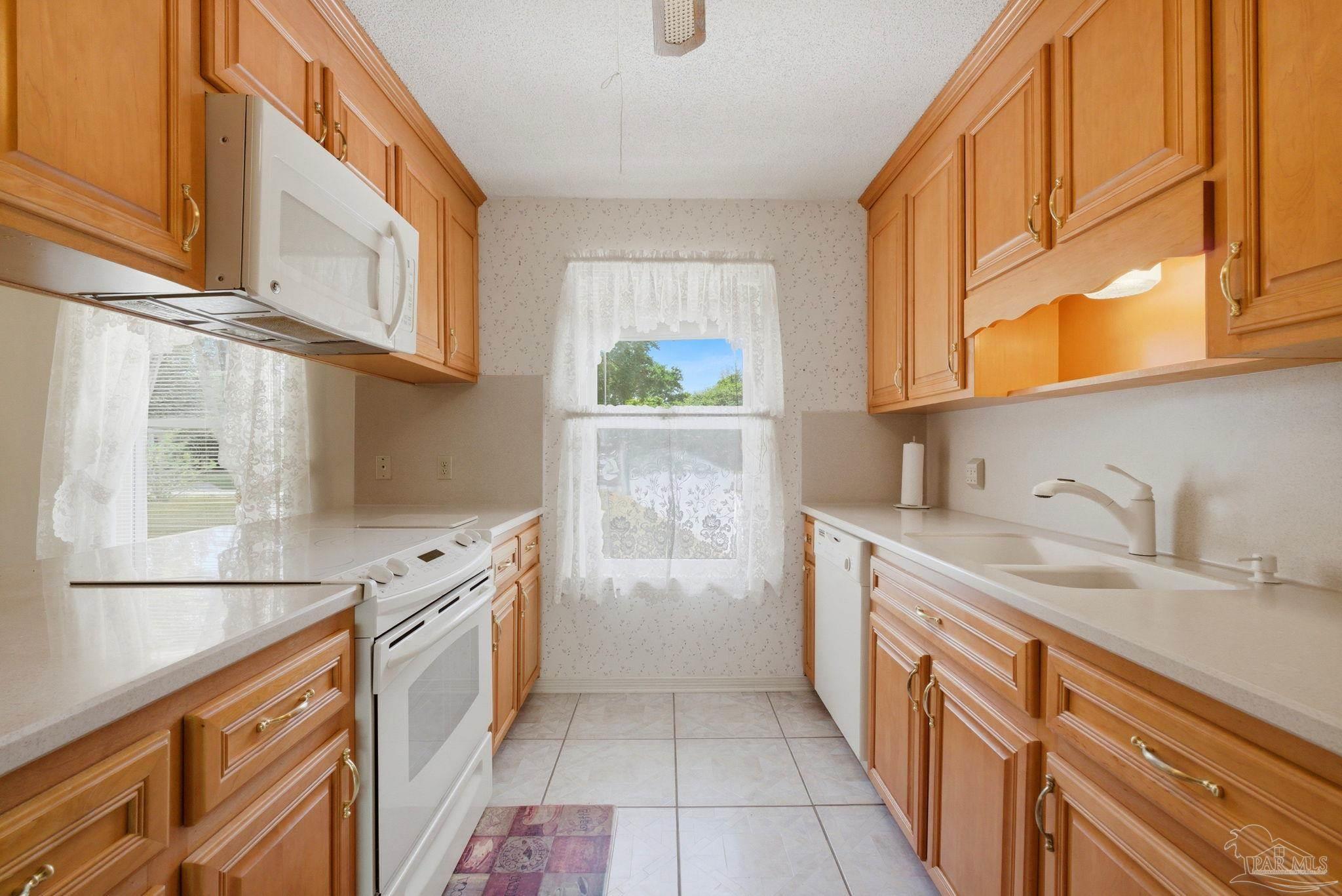 4320 Grant Street Pace, FL 32571 - Photo 13 of 27 a kitchen with stainless steel appliances granite countertop a sink and a stove