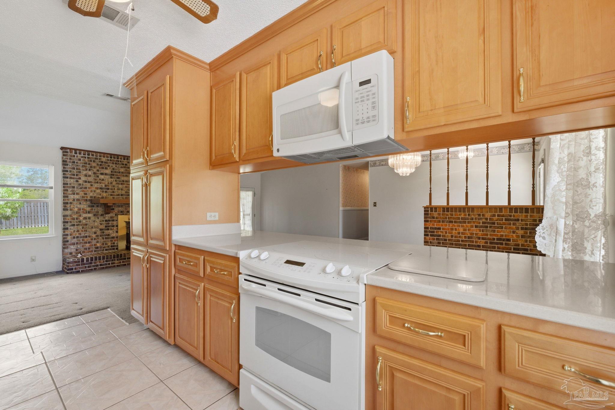 4320 Grant Street Pace, FL 32571 - Photo 15 of 27 a kitchen with stainless steel appliances granite countertop a sink and cabinets