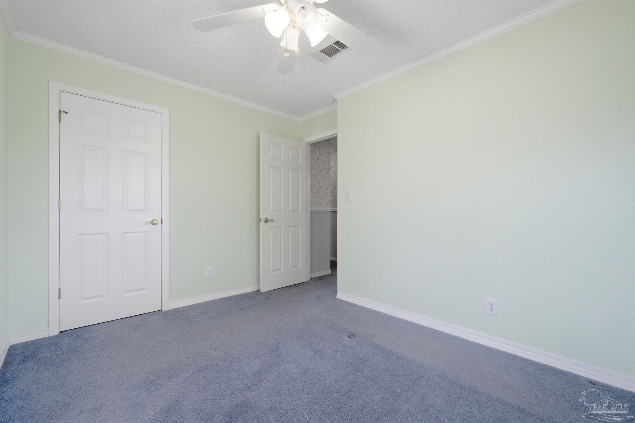 4320 Grant Street Pace, FL 32571 - Photo 19 of 27 an empty room with a chandelier fan