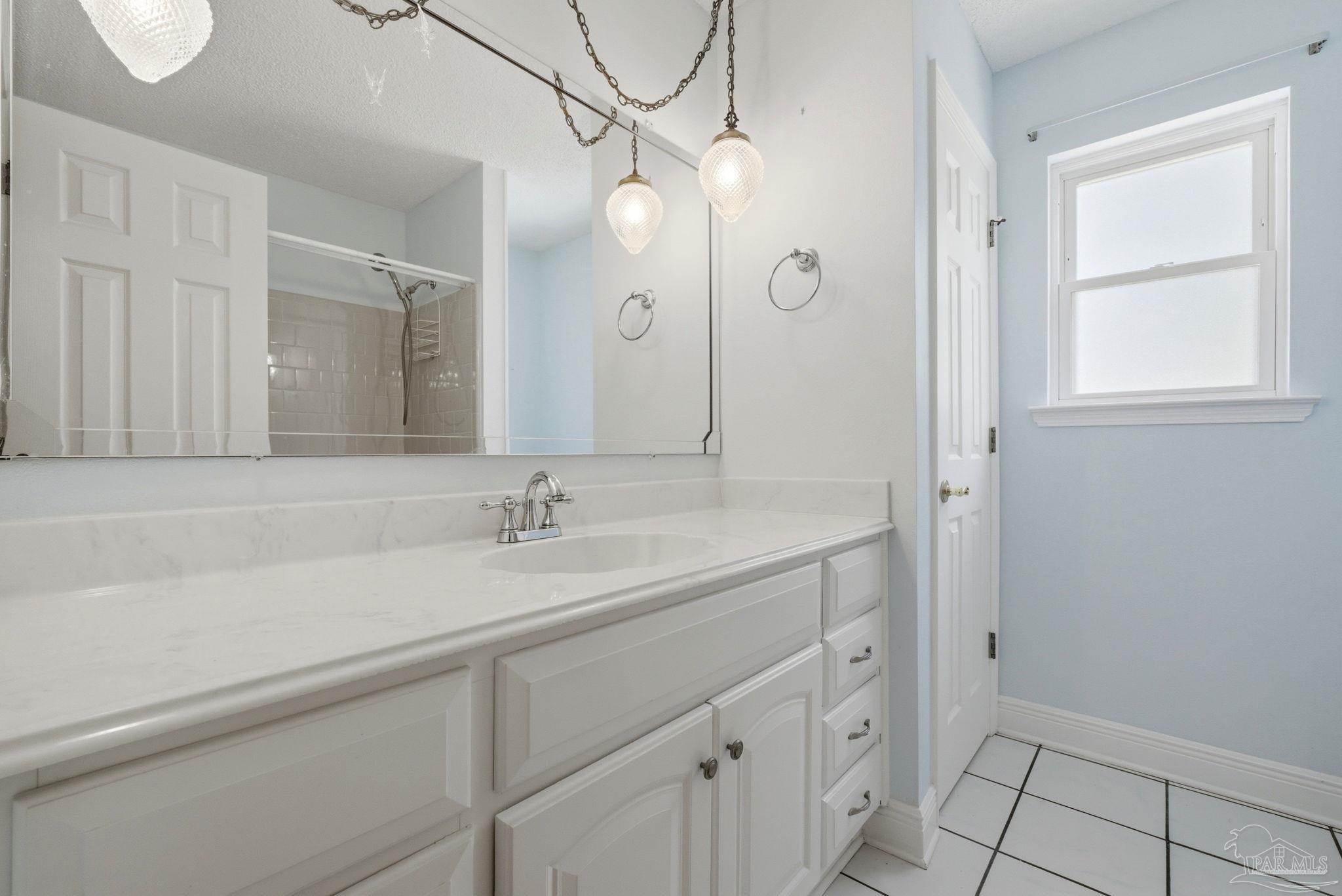 4320 Grant Street Pace, FL 32571 - Photo 20 of 27 a bathroom with a sink and a mirror