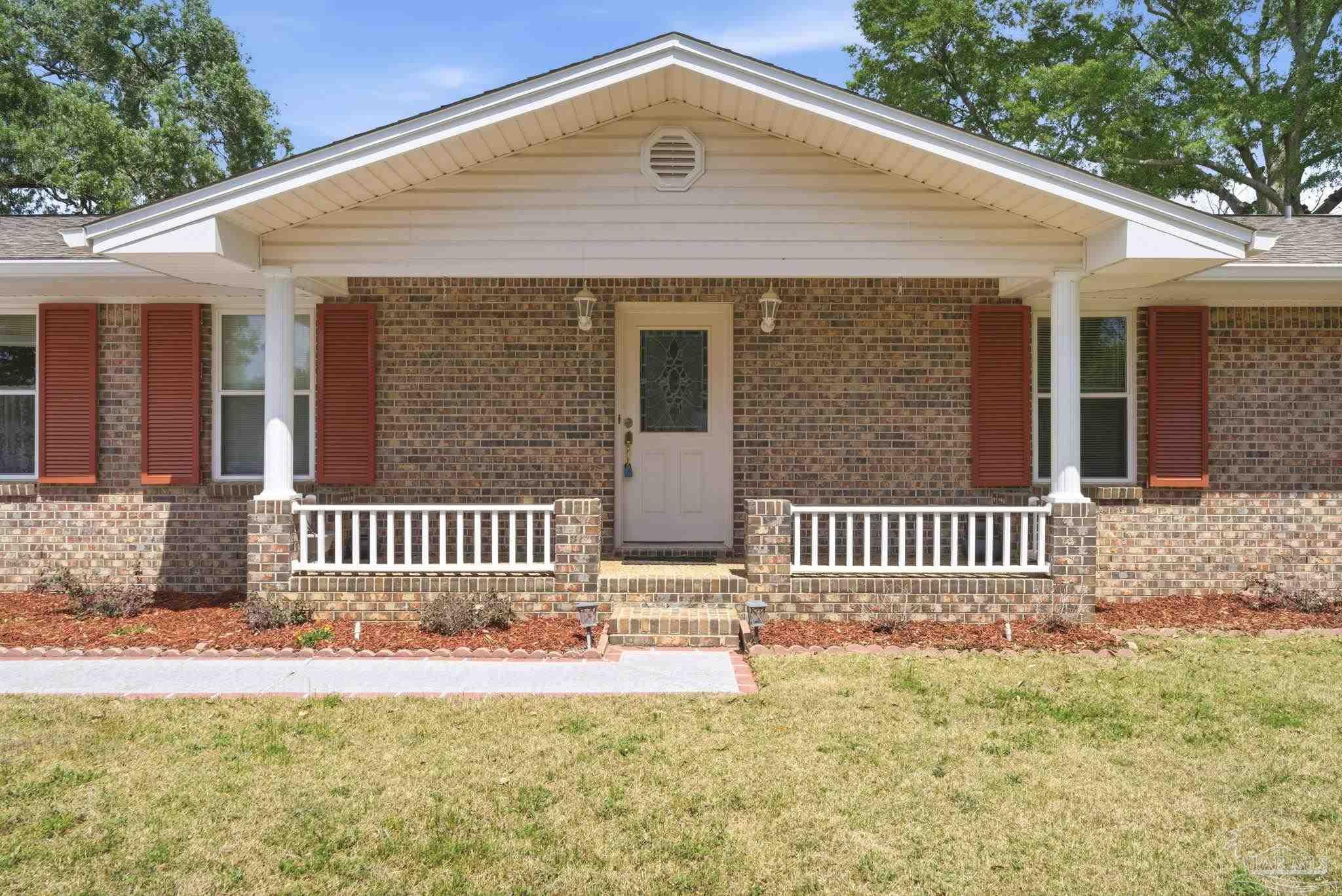4320 Grant Street Pace, FL 32571 - Photo 2 of 27 a front view of a house with a yard