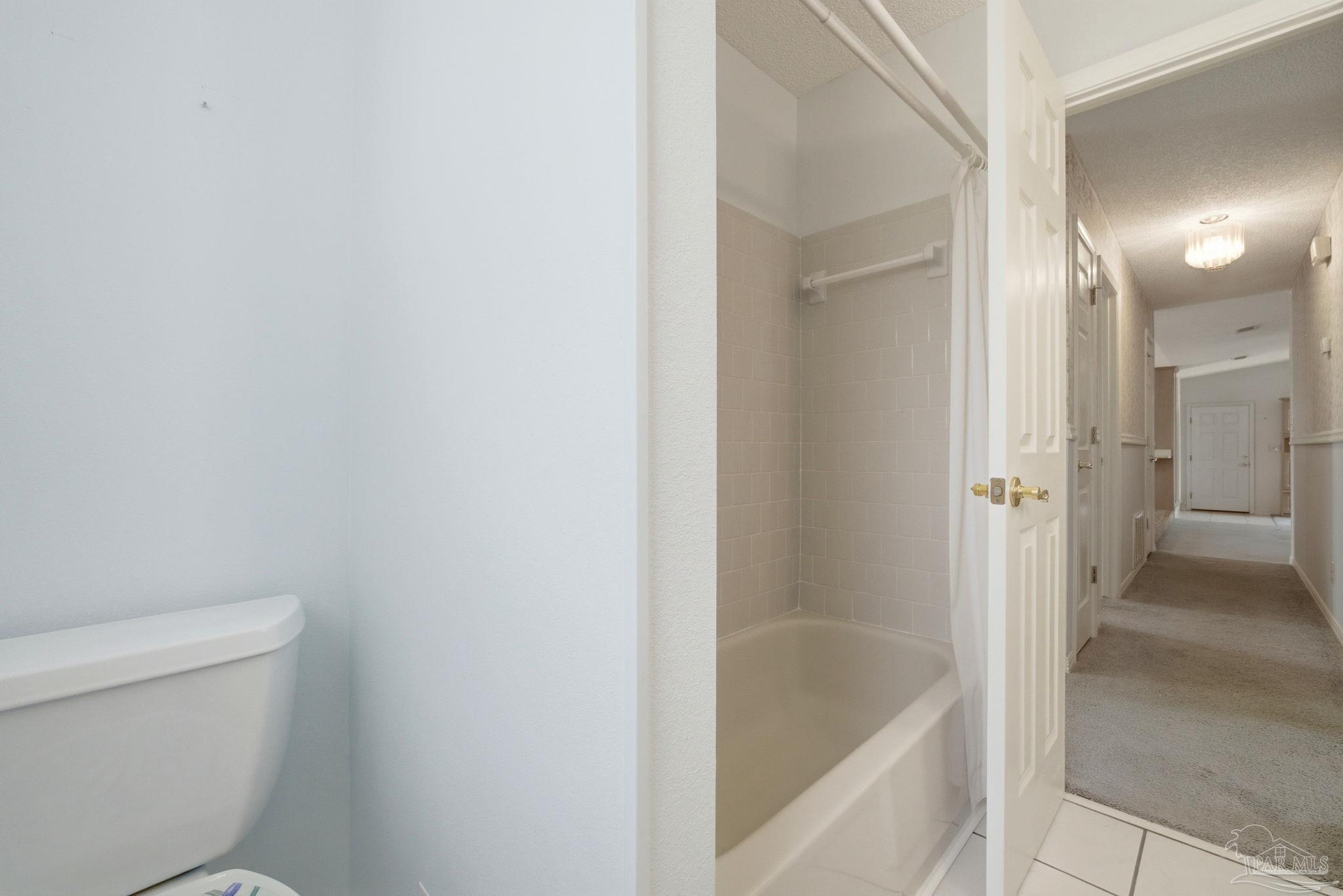 4320 Grant Street Pace, FL 32571 - Photo 21 of 27 a bathroom with a tub and shower