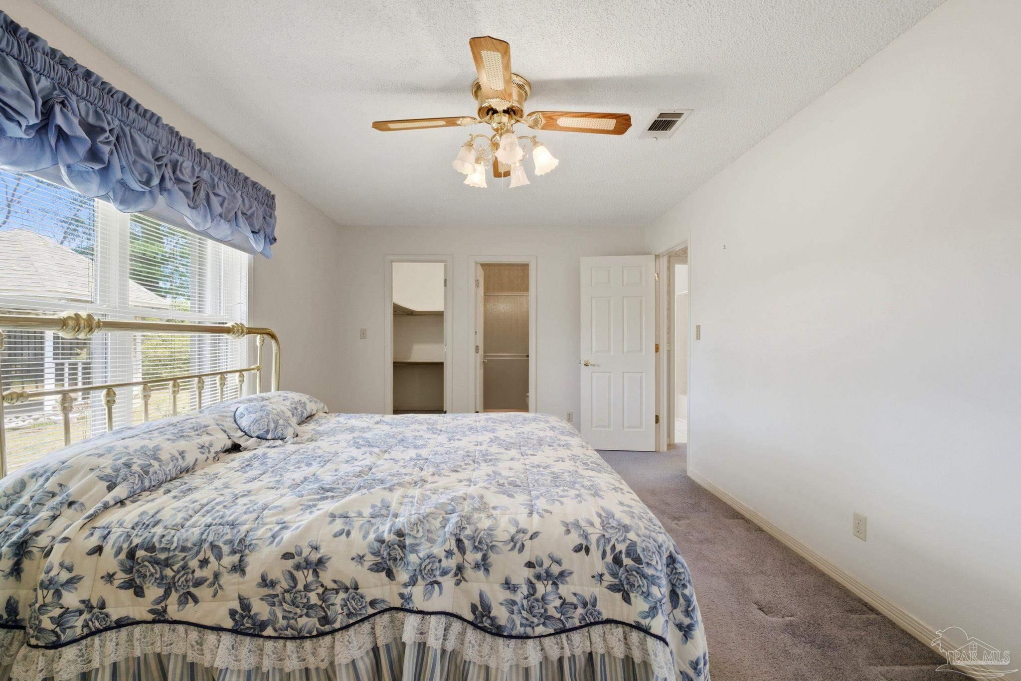 4320 Grant Street Pace, FL 32571 - Photo 23 of 27 a bedroom with a bed and a window