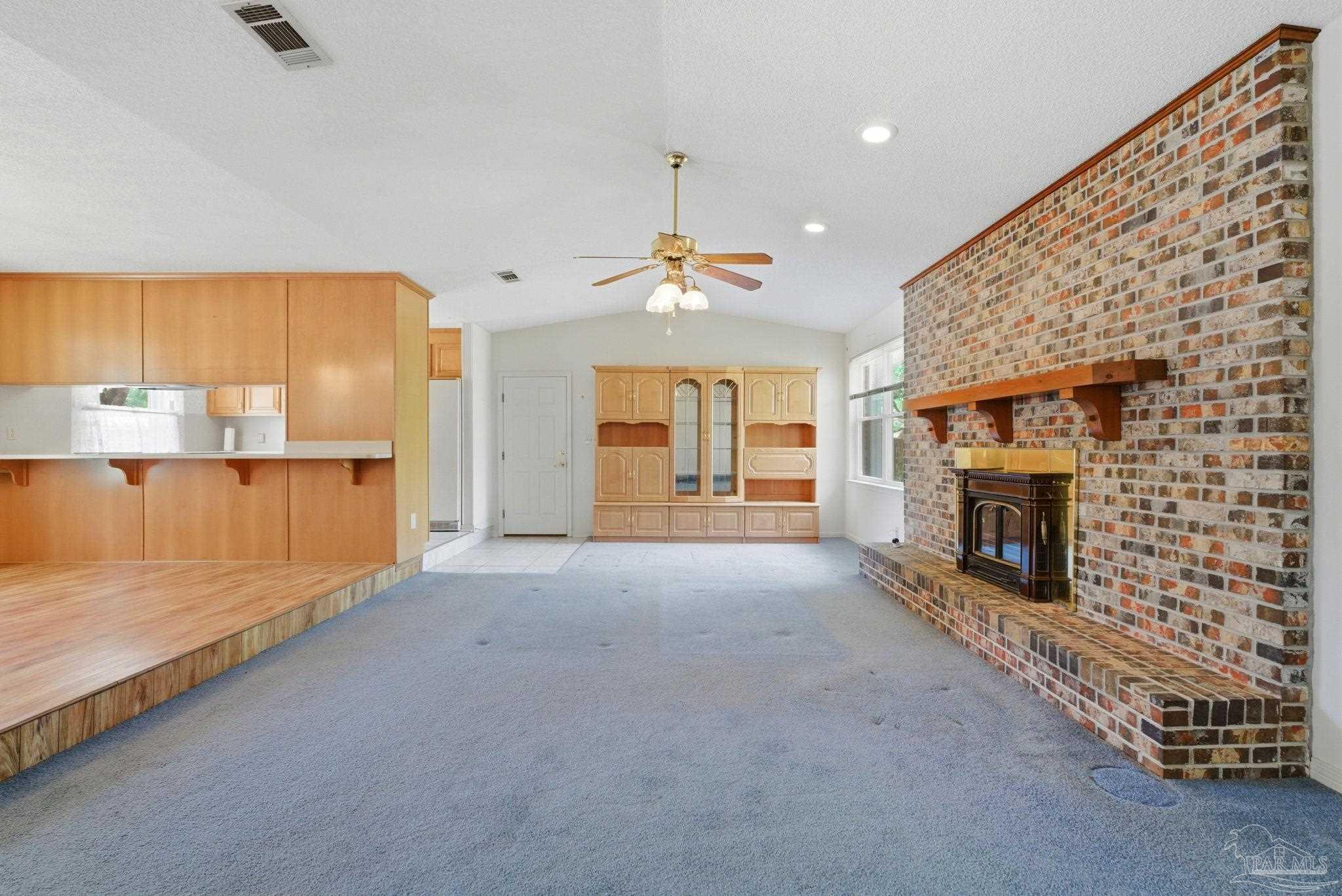 4320 Grant Street Pace, FL 32571 - Photo 5 of 27 an empty room with windows and fireplace