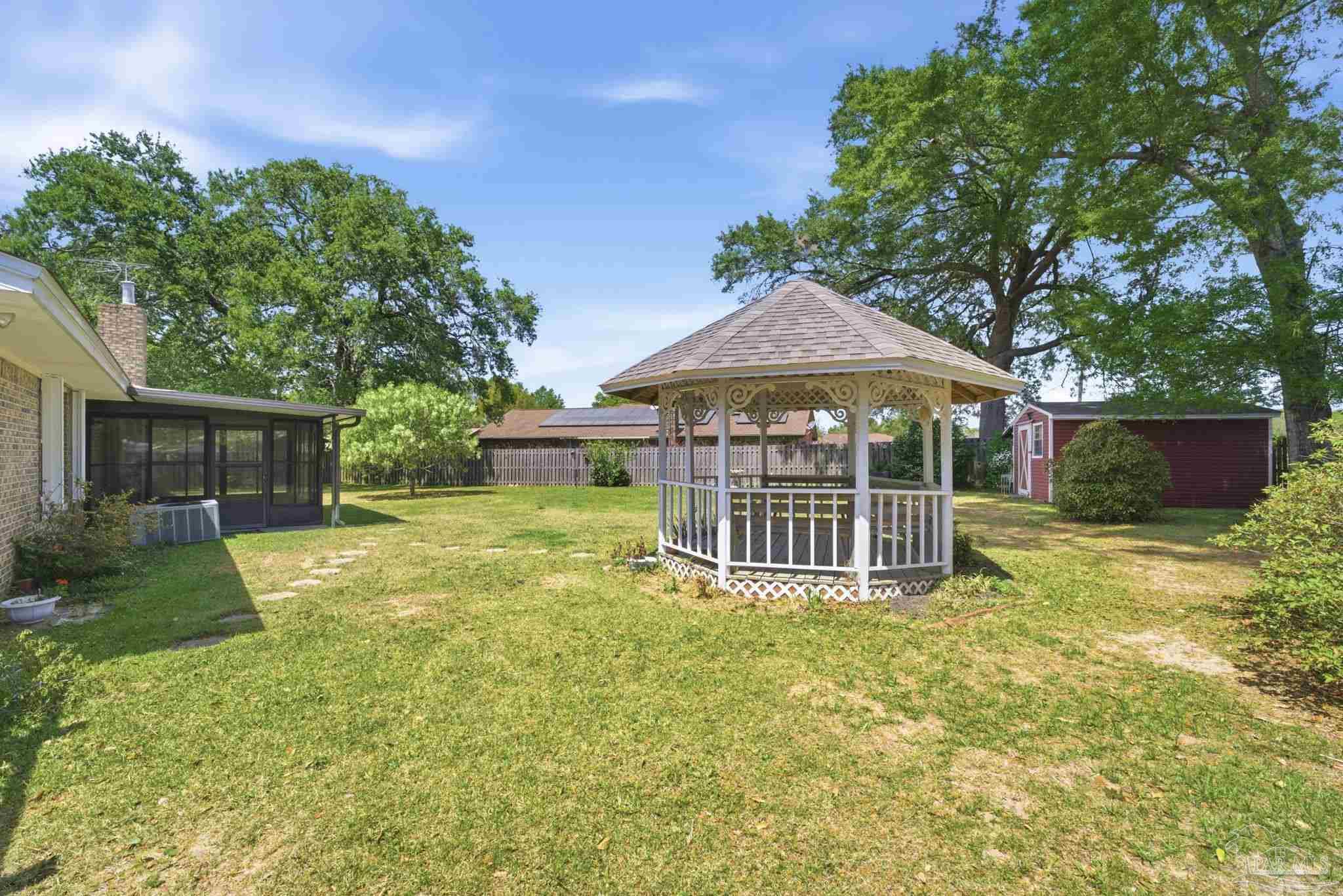 4320 Grant Street Pace, FL 32571 - Photo 7 of 27 a view of a house with a yard