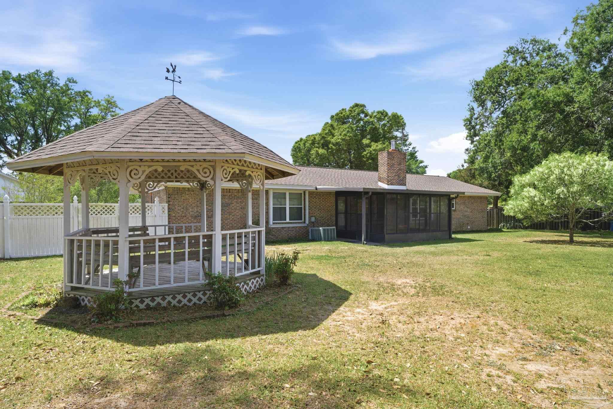 4320 Grant Street Pace, FL 32571 - Photo 9 of 27 a view of a house with a yard