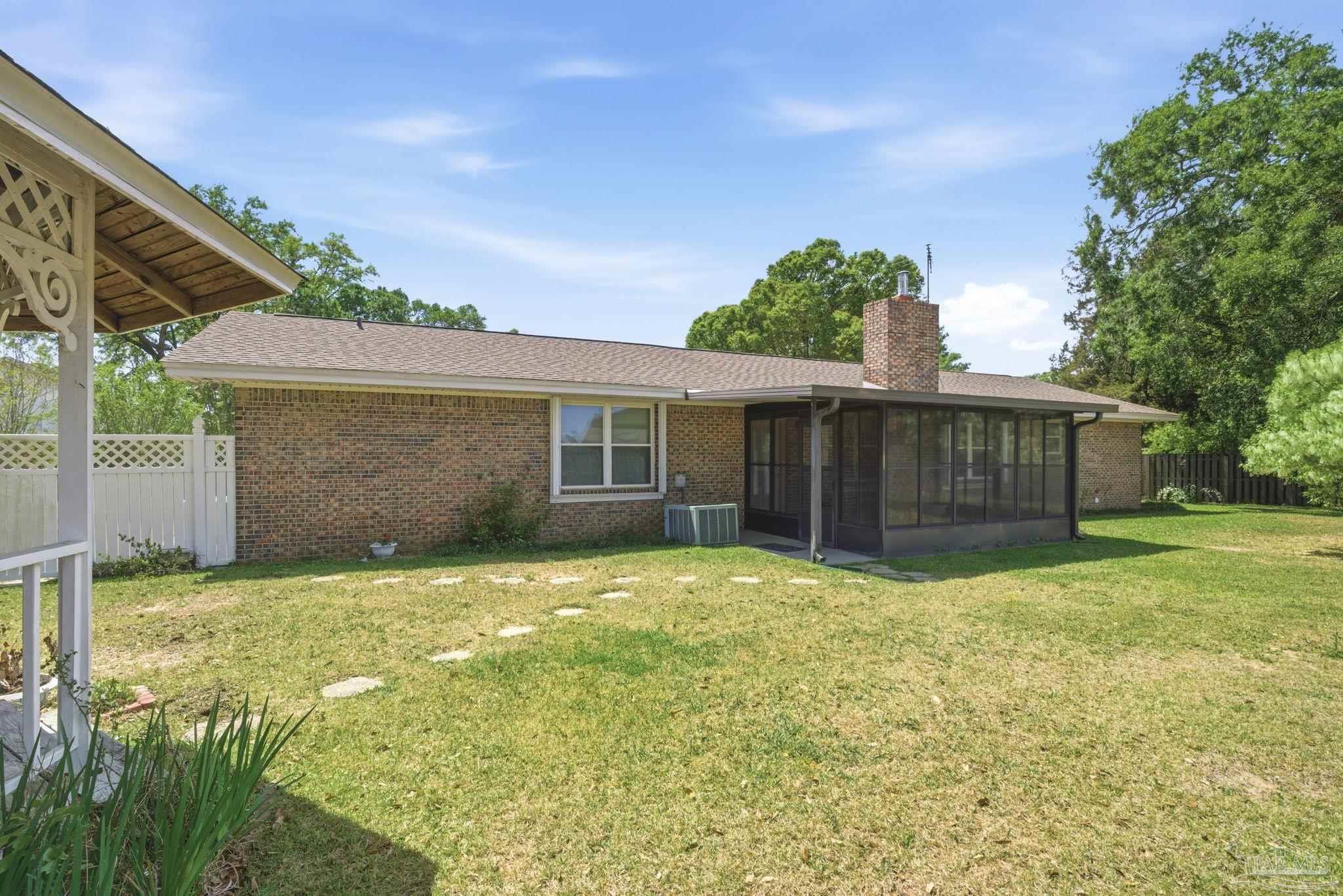 4320 Grant Street Pace, FL 32571 - Photo 10 of 27 a view of a house with a yard