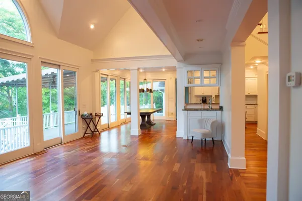 a view of entryway and hall with wooden floor