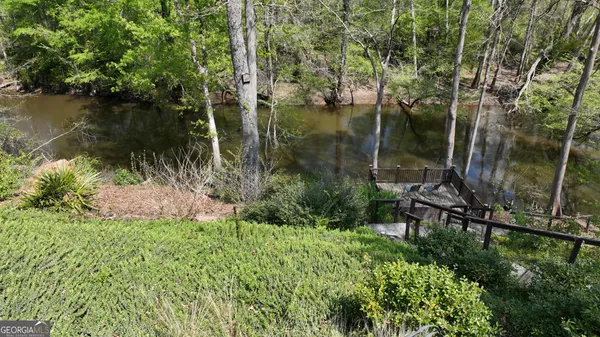 a view of a lake with a house in the background