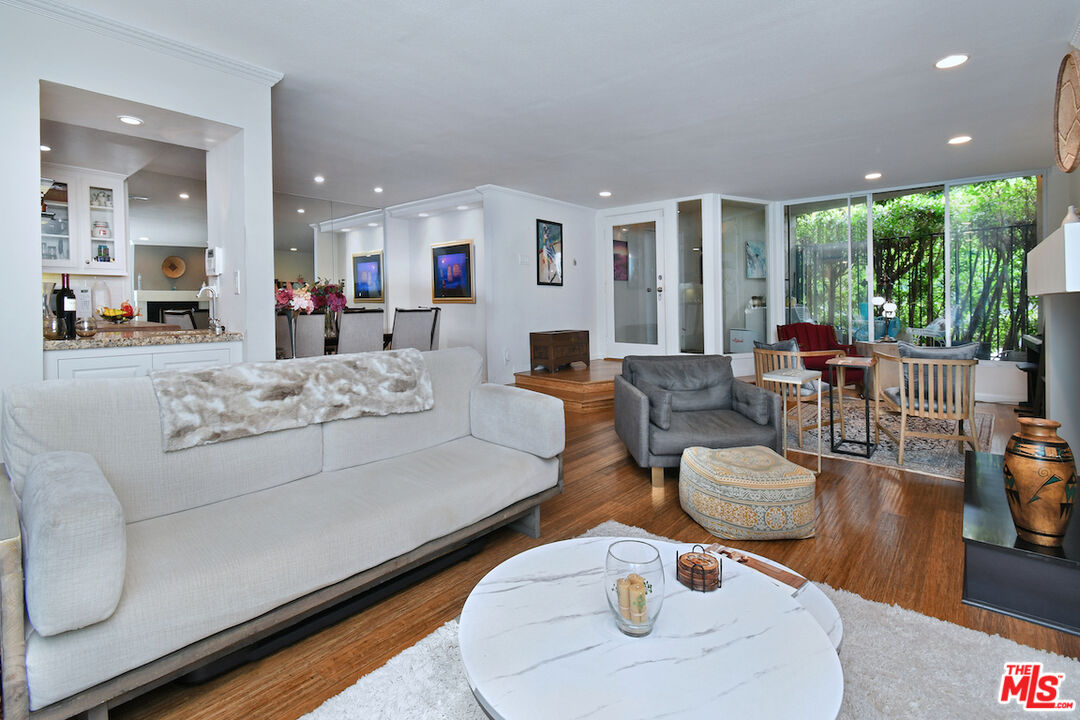 11687 Bellagio Road, Unit 3 Los Angeles, CA 90049 - Photo 16 of 57 a living room with furniture and a large window