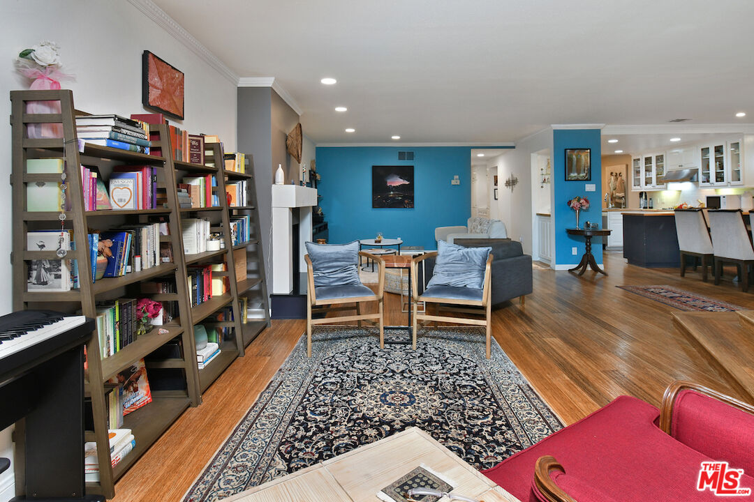11687 Bellagio Road, Unit 3 Los Angeles, CA 90049 - Photo 19 of 57 a living room with furniture and a book shelf