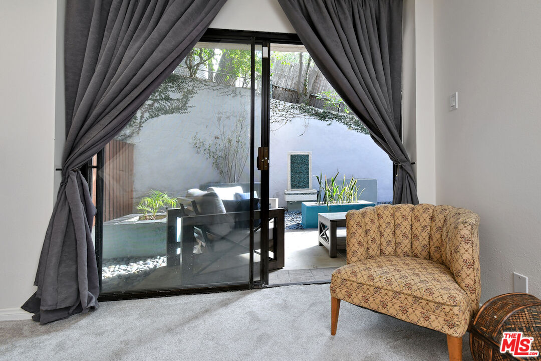 11687 Bellagio Road, Unit 3 Los Angeles, CA 90049 - Photo 34 of 57 a view of livingroom with furniture and a floor to ceiling window