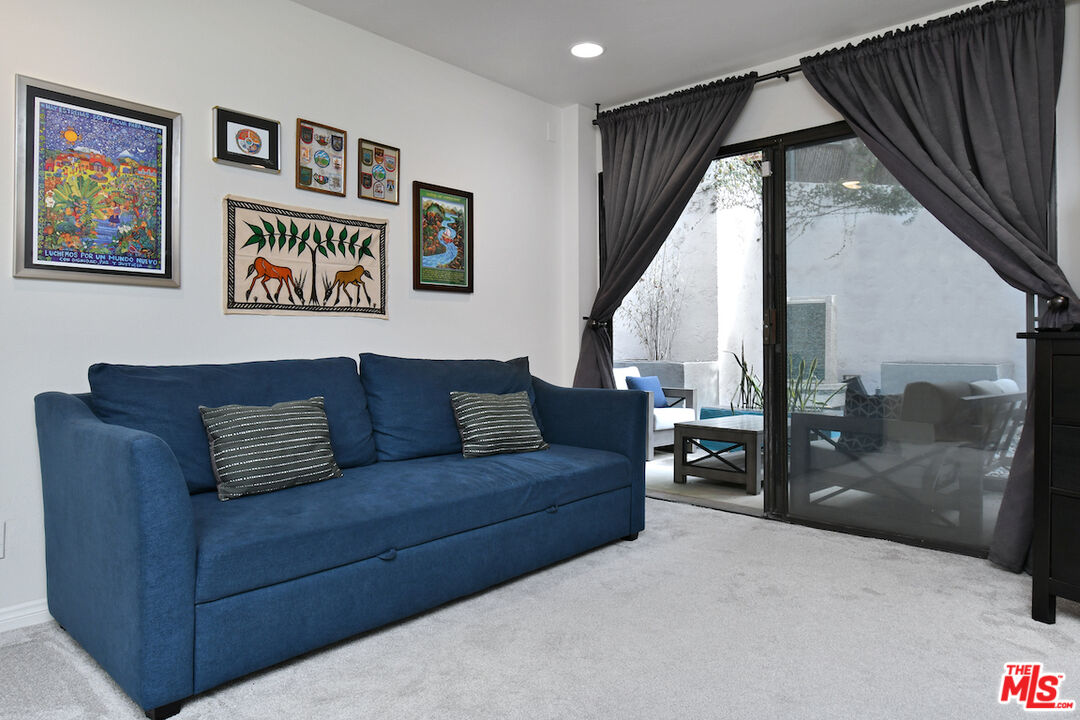 11687 Bellagio Road, Unit 3 Los Angeles, CA 90049 - Photo 41 of 57 a living room with couch and a large window