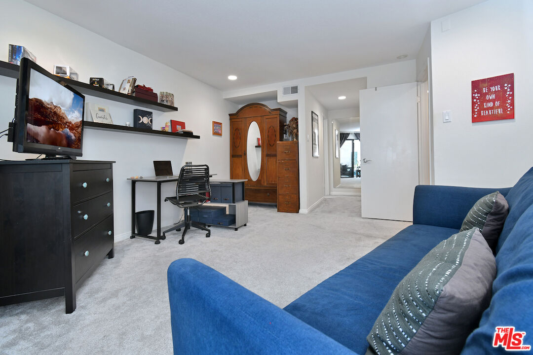 11687 Bellagio Road, Unit 3 Los Angeles, CA 90049 - Photo 42 of 57 a living room with furniture and a wooden floor