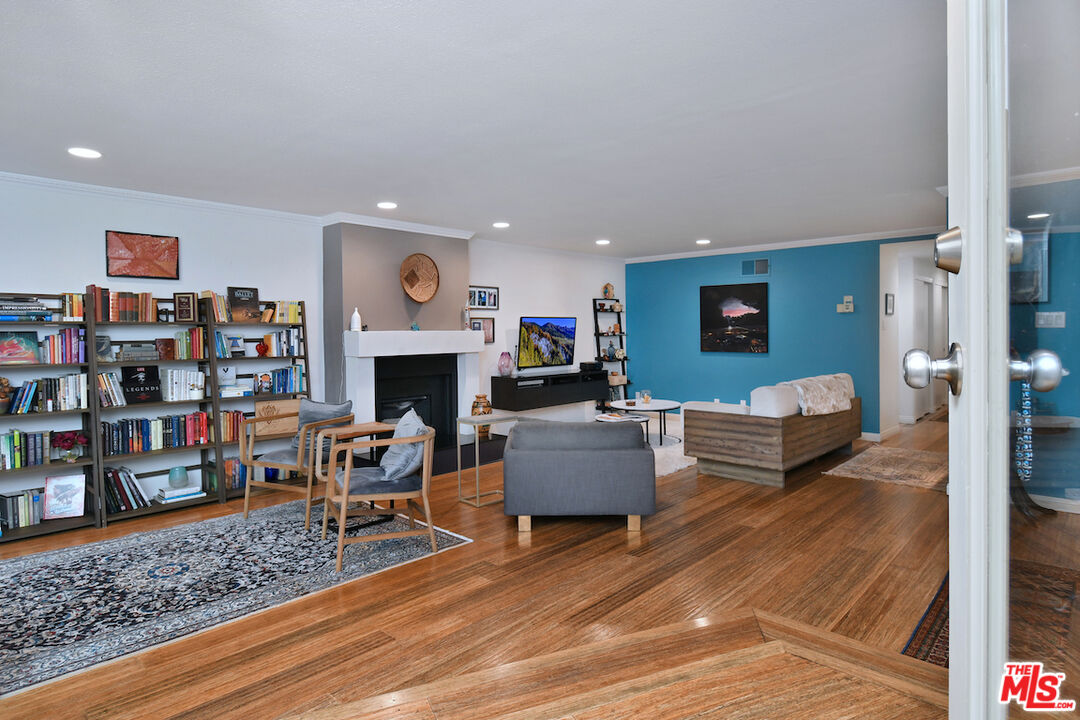 11687 Bellagio Road, Unit 3 Los Angeles, CA 90049 - Photo 9 of 57 a living room with furniture and a fireplace