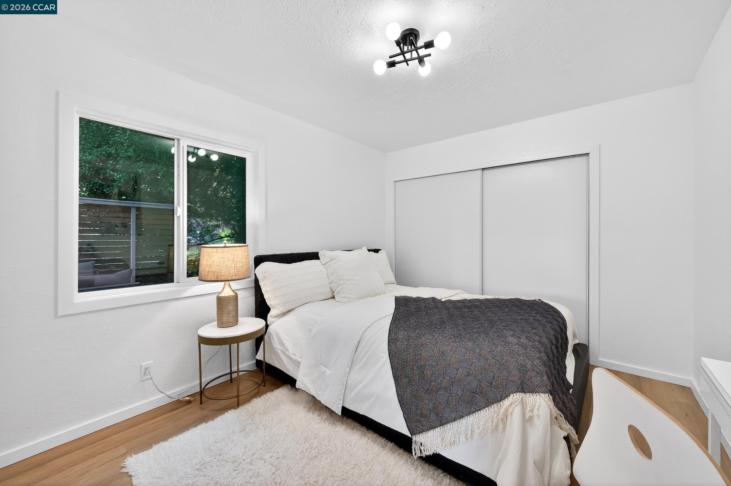 230 Fairlawn Drive Berkeley, CA 94708 - Photo 27 of 58 a bedroom with a bed and a window