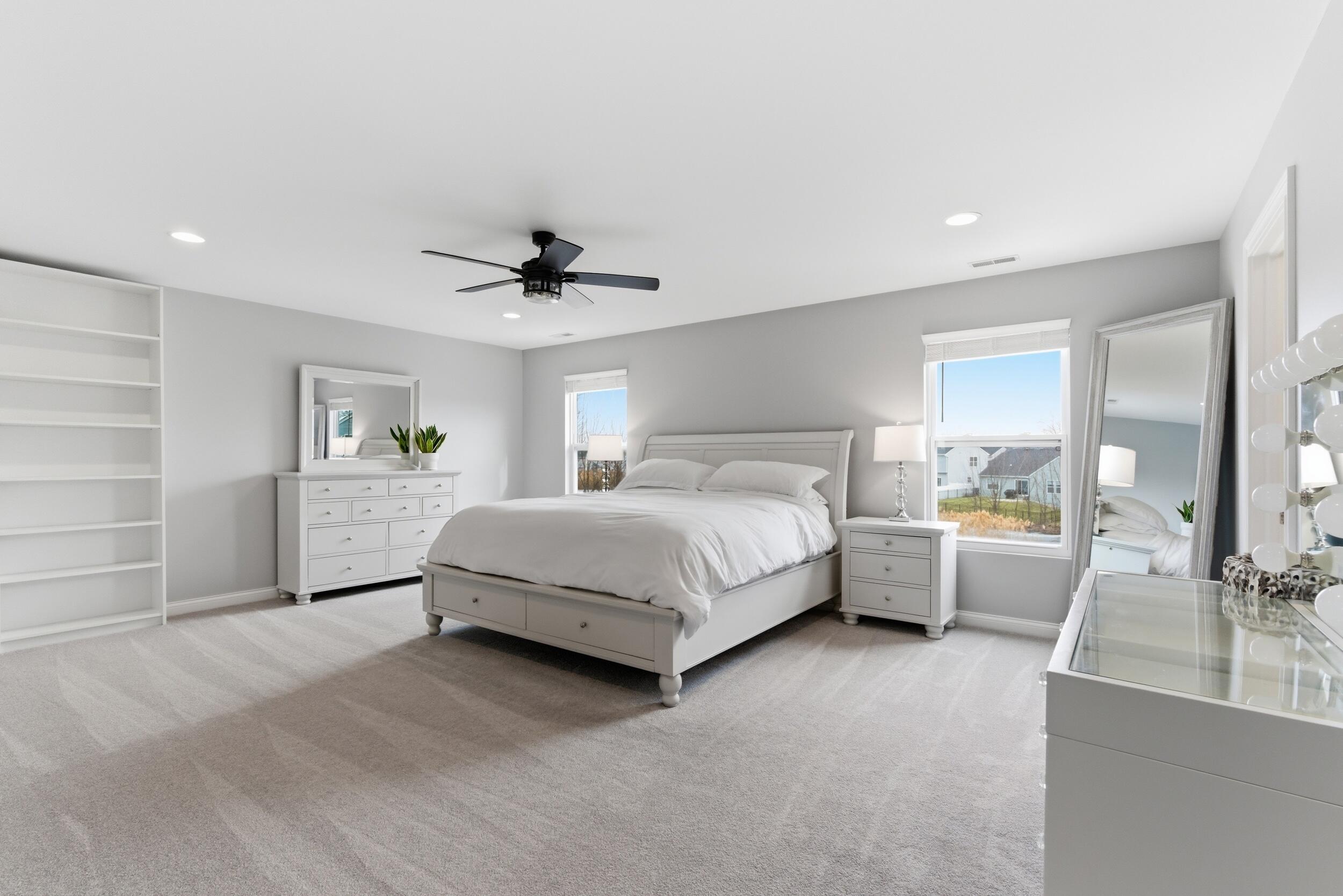 13181 Taft Street Crown Point, IN 46307 - Photo 15 of 42 a bedroom with a large bed and a chandelier