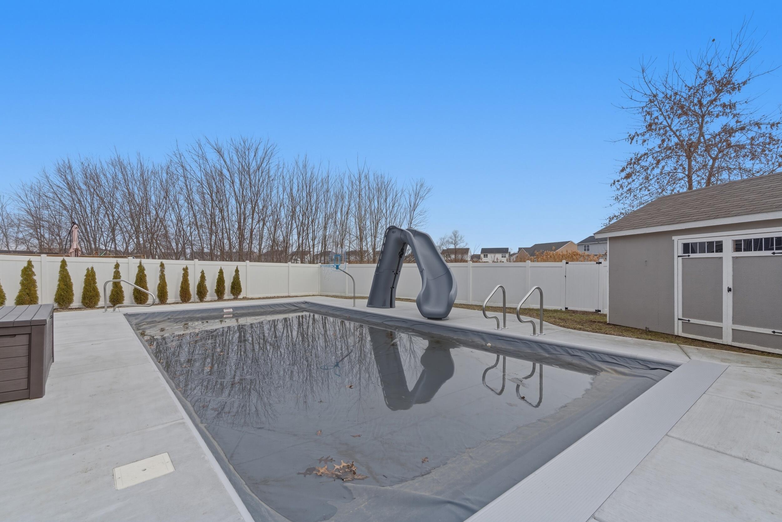 13181 Taft Street Crown Point, IN 46307 - Photo 6 of 42 a view of a swimming pool with a patio and mountain view