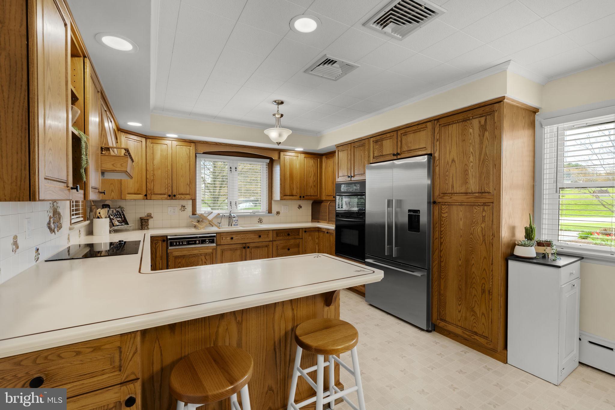 218 Lauschtown Road Denver, PA 17517 - Photo 29 of 78 a kitchen with stainless steel appliances a sink stove and refrigerator