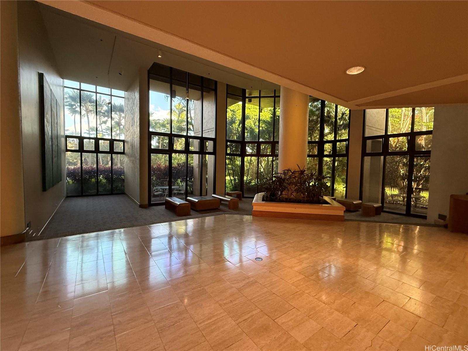 5333 Likini Street, Unit 1008 Honolulu, HI 96818 - Photo 12 of 17 a living room with hardwood floor and large windows