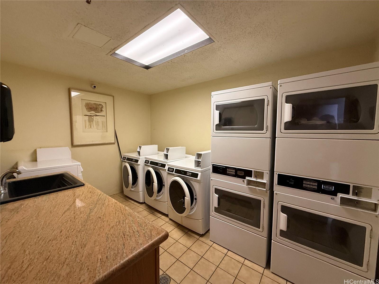 5333 Likini Street, Unit 1008 Honolulu, HI 96818 - Photo 15 of 17 a bedroom with a bed and a flat screen tv