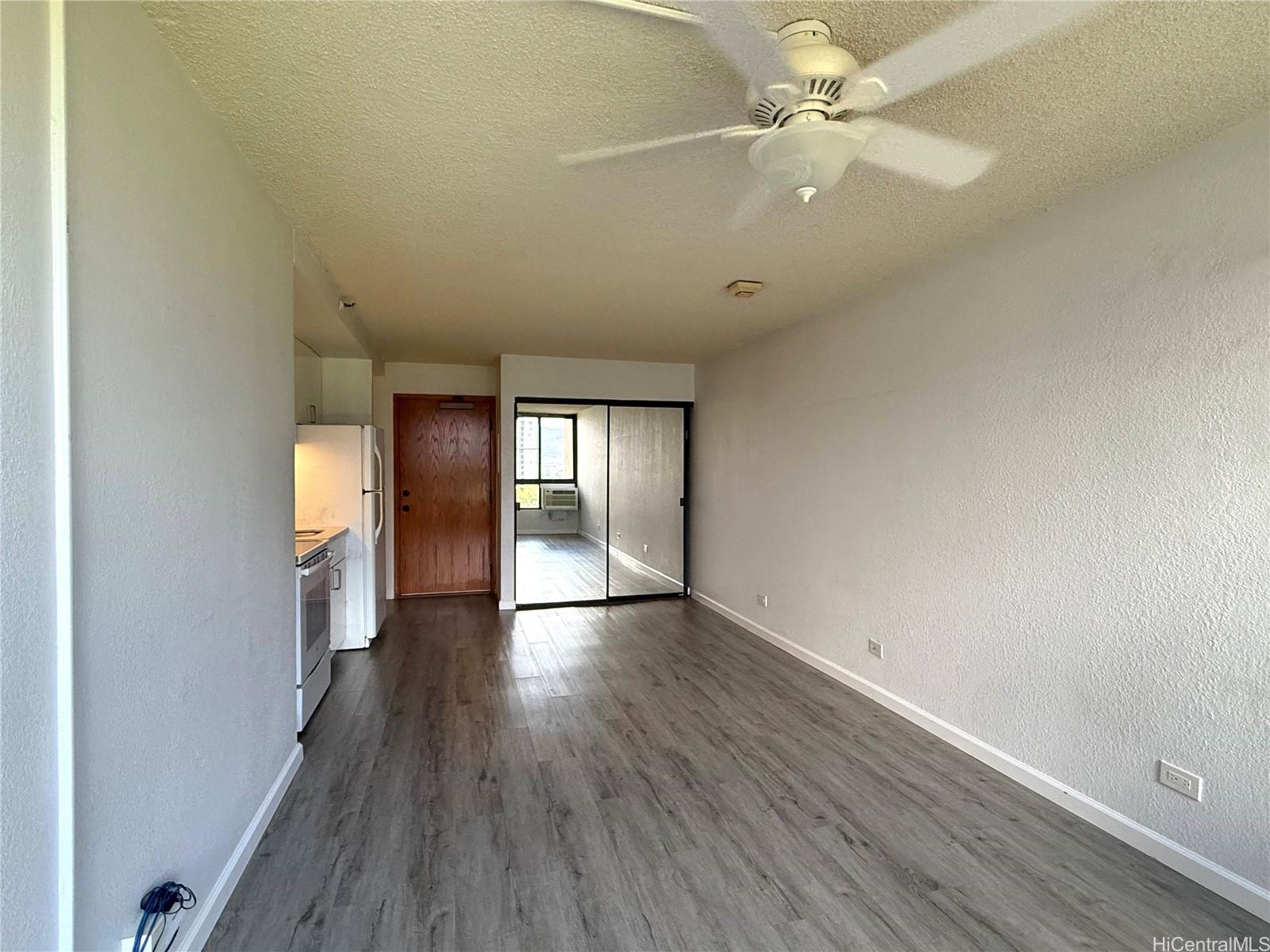 5333 Likini Street, Unit 1008 Honolulu, HI 96818 - Photo 4 of 17 wooden floor in an empty room with a window