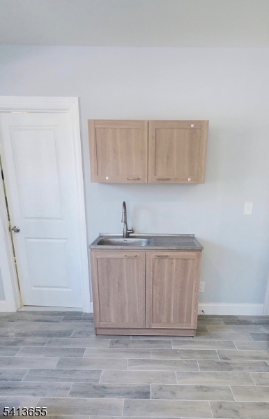 80 South Devine Street Newark, NJ 07106 - Photo 3 of 4 a kitchen with a sink and cabinets