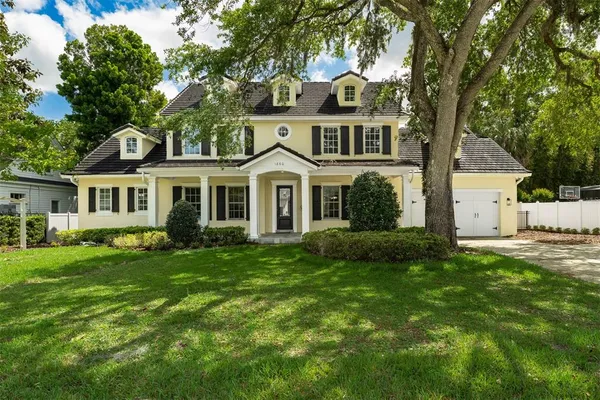 a front view of a house with a garden