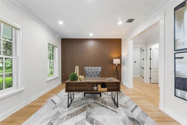 a kitchen with kitchen island granite countertop a stove a sink a dining table and chairs with wooden floor