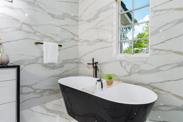 a bathroom with a granite countertop toilet a sink and a mirror