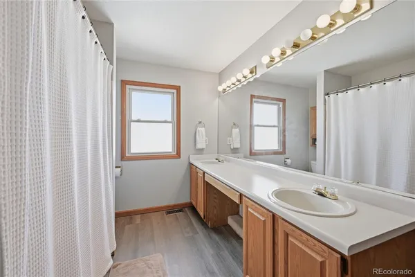 a bathroom with a bathtub a sink and a window