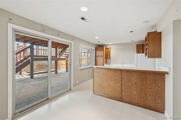 a kitchen with a sink and a refrigerator