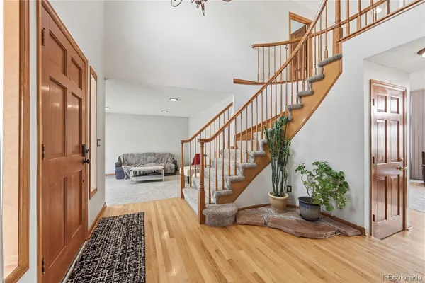 a view of entryway and hall with wooden floor