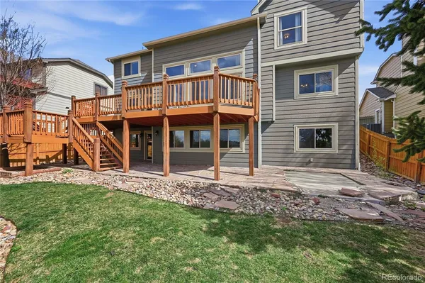 a view of a house with deck and wooden floor