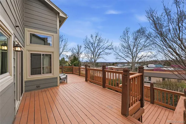 a view of balcony with wooden floor and fence