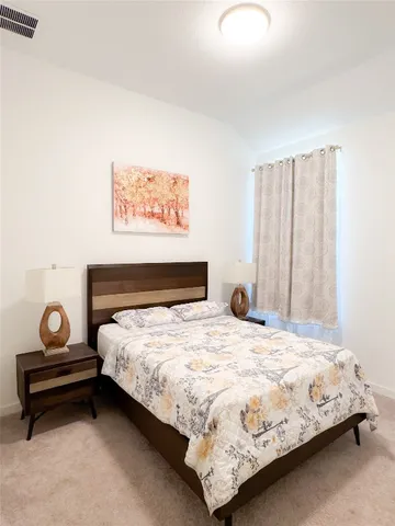 a bedroom with a bed and window