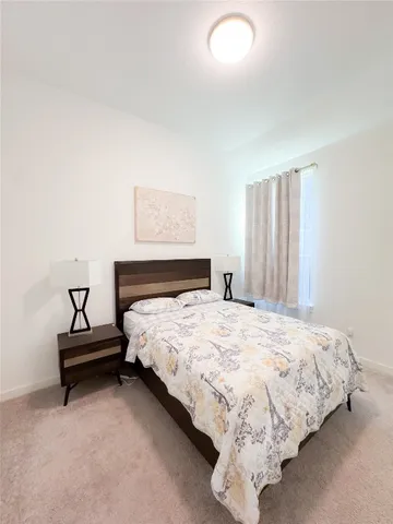 a bedroom with bed and a window