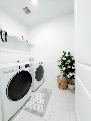 a view of a storage & utility room with a sink dryer and washer