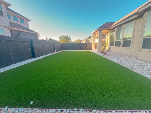 a backyard of a house with lots of green space