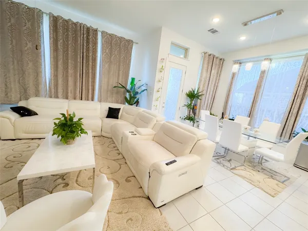 a living room with furniture and a potted plant