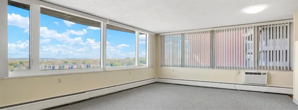 a view of an empty room with a window