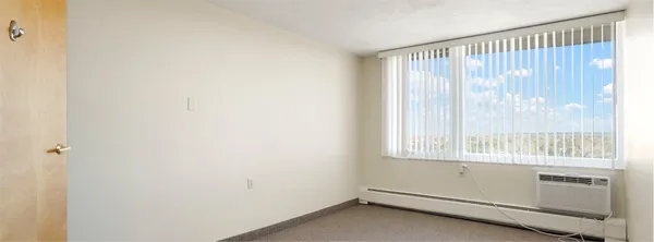 a room with a window and a kitchen