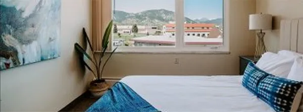 a bedroom with a bed and a flat tv screen on the table
