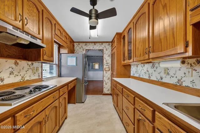 a kitchen with stainless steel appliances granite countertop a stove and a sink