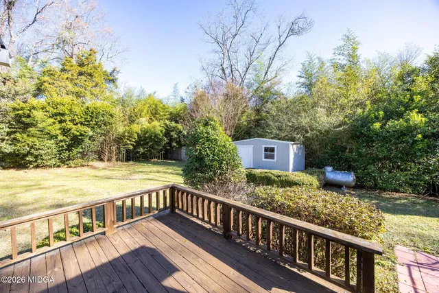 a view of balcony with wooden floor and fence