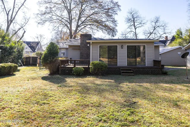 a view of a house with a yard covered in snow