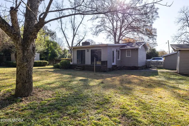 a view of a house with a yard covered in snow