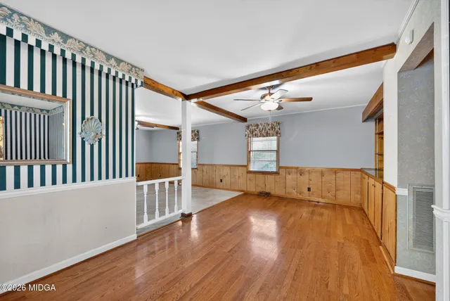 a view of hallway with stairs and wooden floor