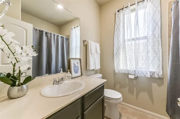a view of a house with backyard and wooden fence