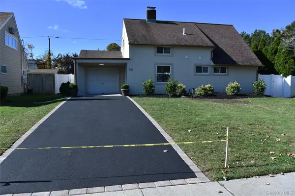 a view of a house with a backyard